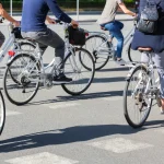 group of people riding bicycle on a city street