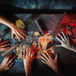 Top view of hands in quest game. Solving a puzzle during riddle. Escape the room game concept