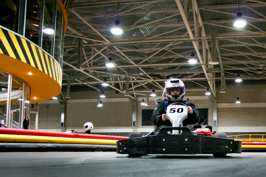 The man is in the go-kart on the karting track