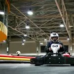The man is in the go-kart on the karting track