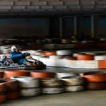 Dynamic karting competition at speed with blurry motion on an equipped racecourse