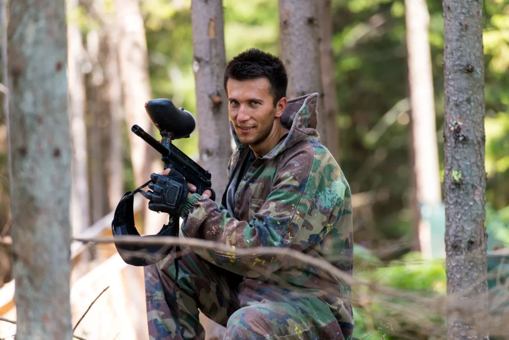 Players in paintball prepare for fight