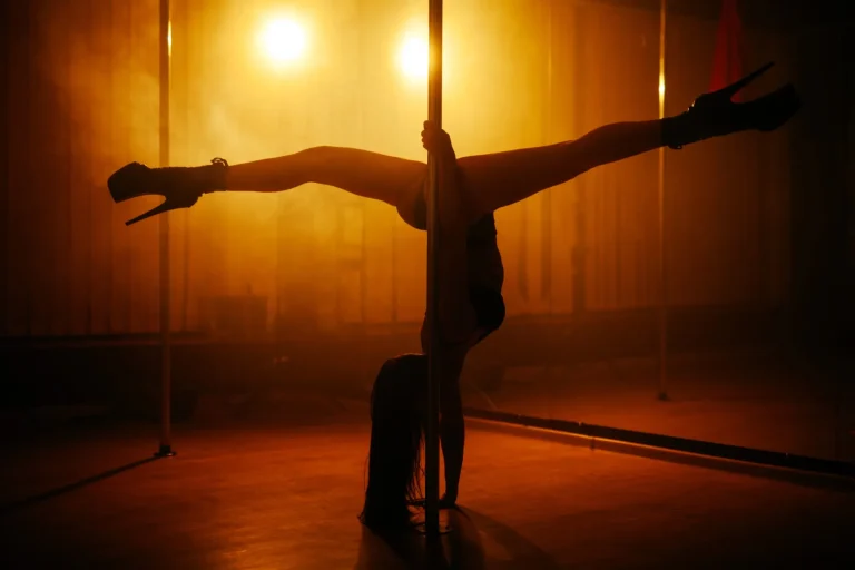 girl dancing striptease in a dark room with a red light