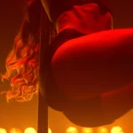 Fit woman dancing erotic moves in strip club. Closeup body performing poledance