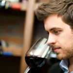 Man tasting a glass of red wine