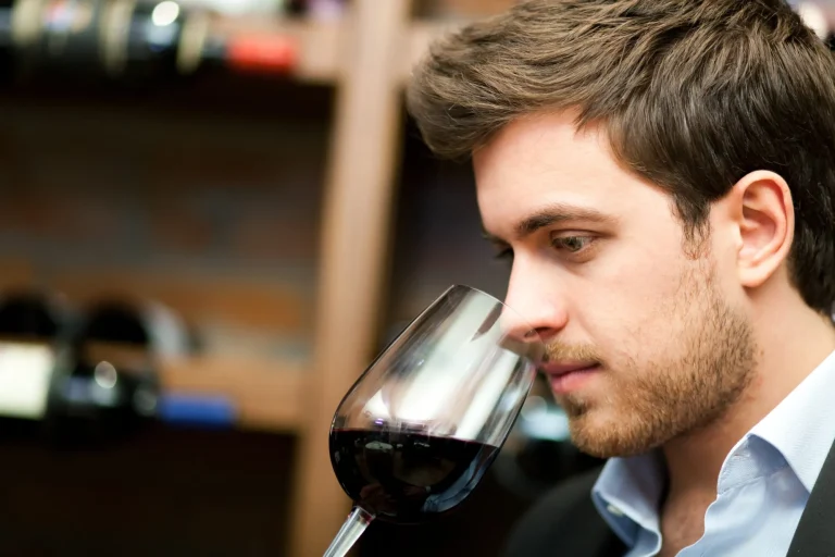 Man tasting a glass of red wine